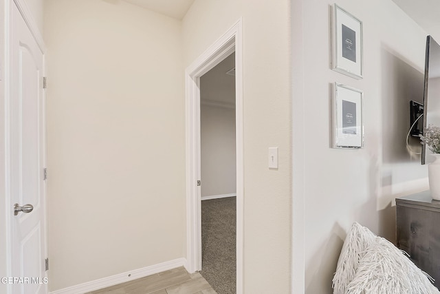 hallway with light hardwood / wood-style flooring