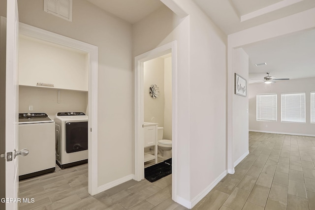 hallway featuring washing machine and clothes dryer