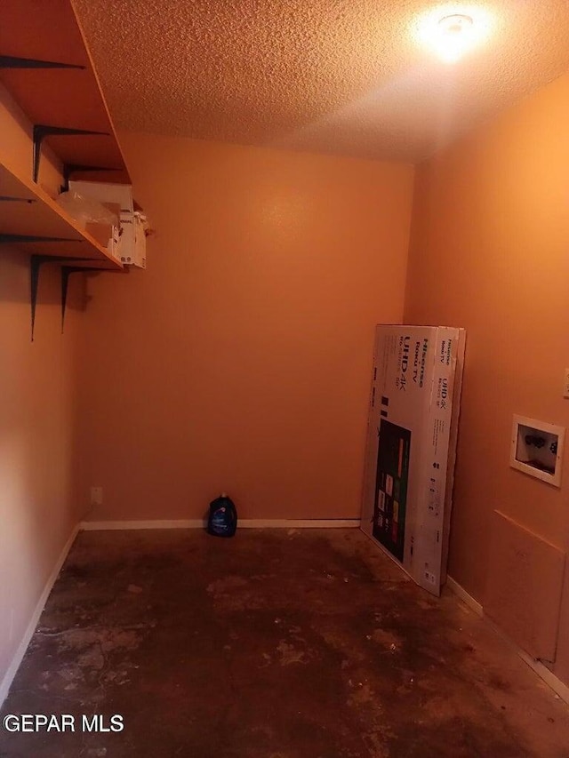 laundry room with hookup for a washing machine and a textured ceiling