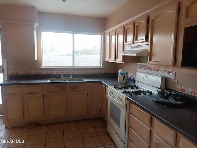 kitchen featuring tile patterned flooring, sink, light brown cabinetry, and gas range gas stove