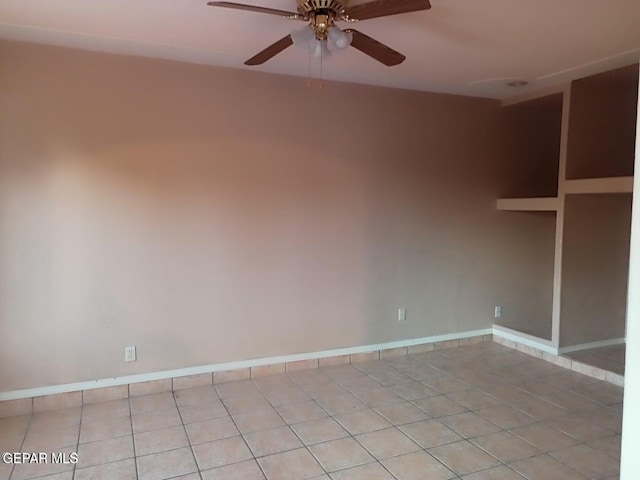 unfurnished room with ceiling fan and light tile patterned floors