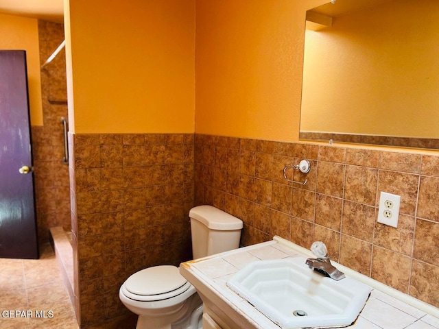 bathroom featuring walk in shower, sink, tile walls, and toilet