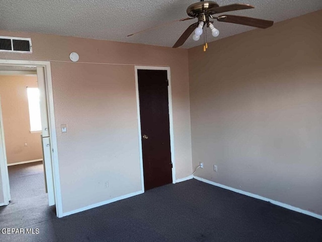 unfurnished bedroom featuring ceiling fan, carpet flooring, and a textured ceiling