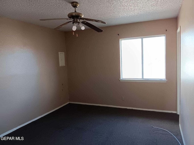 carpeted spare room with ceiling fan and a textured ceiling