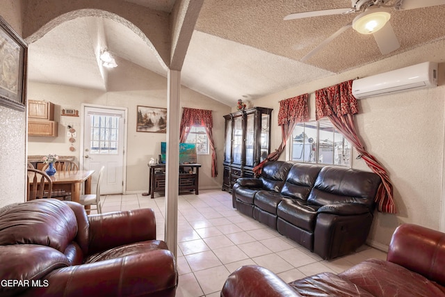 living room featuring lofted ceiling, light tile patterned floors, a wall unit AC, and a textured ceiling