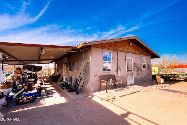 back of property with a patio