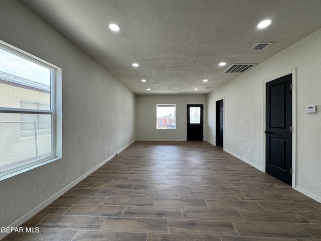 spare room with visible vents, wood finish floors, and recessed lighting