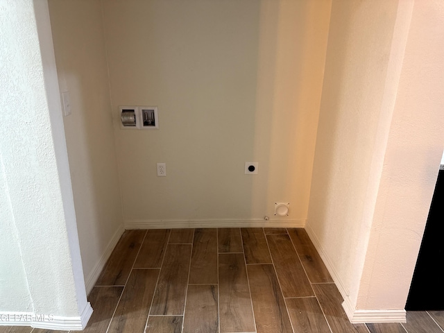 washroom with electric dryer hookup, laundry area, baseboards, wood tiled floor, and gas dryer hookup
