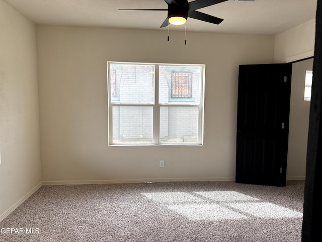 unfurnished bedroom with baseboards, carpet flooring, and a ceiling fan