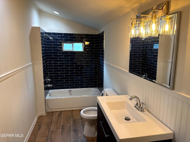 full bath with toilet, vaulted ceiling, wainscoting, and wood finish floors