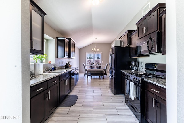 kitchen with dark brown cabinetry, sink, light stone counters, hanging light fixtures, and black appliances