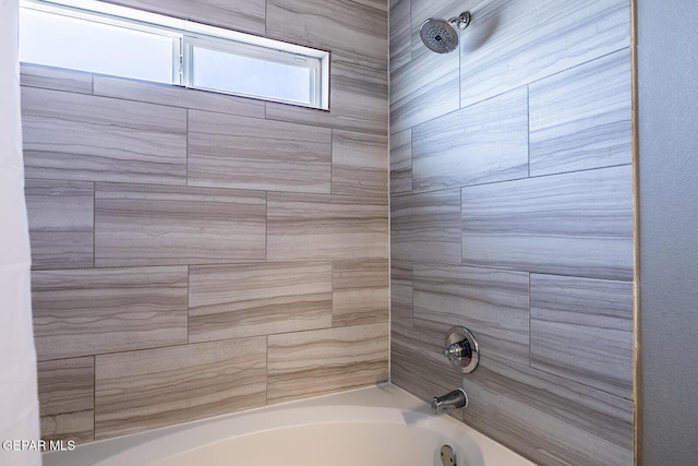 bathroom featuring tiled shower / bath