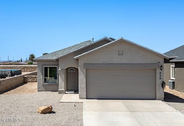 single story home featuring central AC and a garage