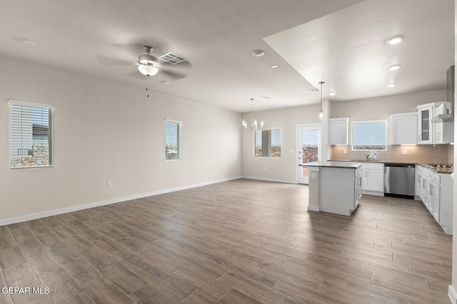 kitchen with white cabinetry, hardwood / wood-style floors, pendant lighting, and stainless steel appliances