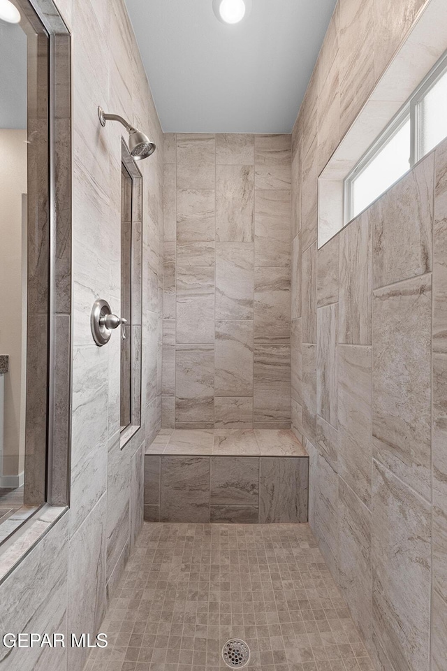 bathroom with a tile shower