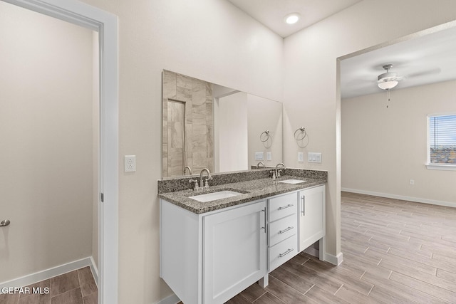 bathroom featuring vanity, ceiling fan, and walk in shower