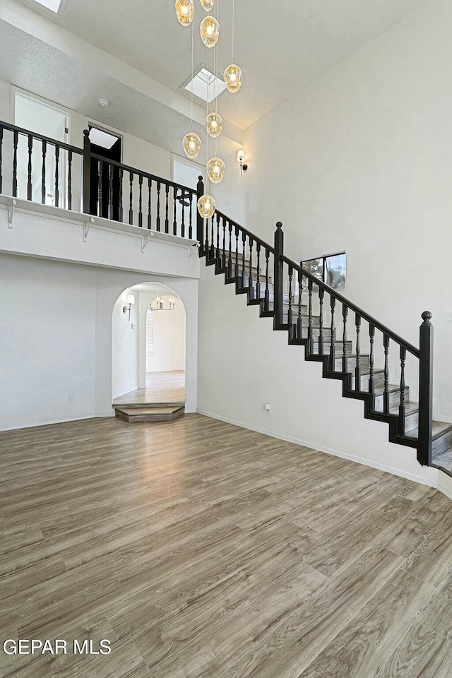 interior space featuring wood-type flooring and a high ceiling