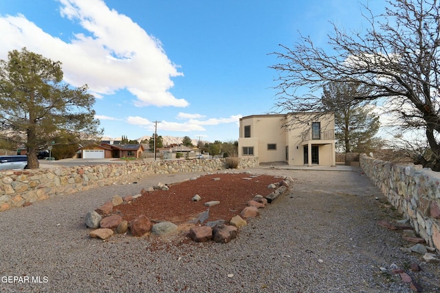 view of yard featuring a garage and a patio area