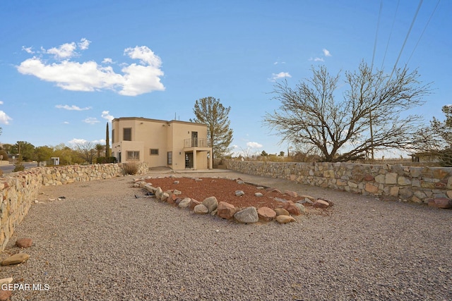 rear view of property with a balcony