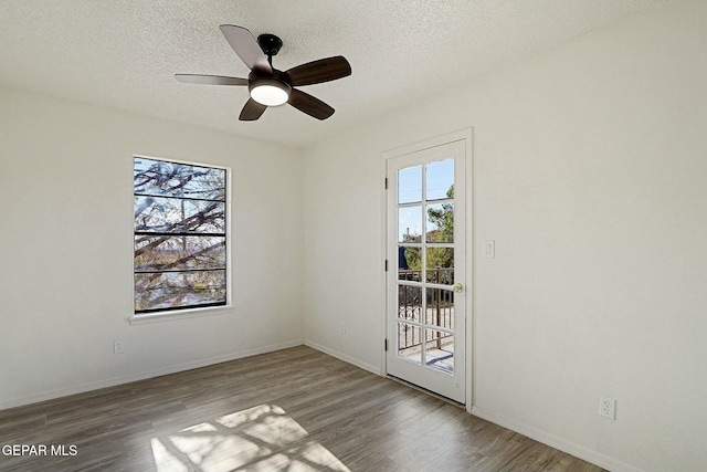 spare room featuring ceiling fan, hardwood / wood-style floors, and a textured ceiling