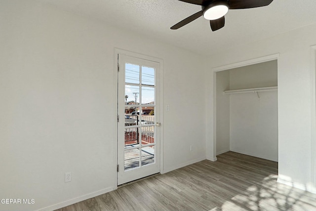 unfurnished bedroom featuring a closet, ceiling fan, and light wood-type flooring