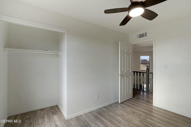 unfurnished bedroom featuring ceiling fan and light hardwood / wood-style flooring