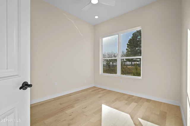 spare room with light hardwood / wood-style flooring, plenty of natural light, and ceiling fan