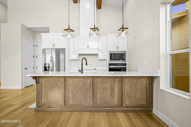 kitchen featuring built in microwave, white cabinetry, sink, stainless steel fridge, and wall oven