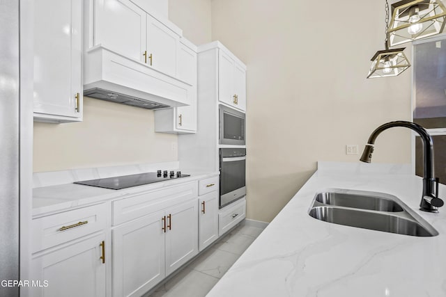 kitchen with decorative light fixtures, sink, white cabinets, light stone counters, and stainless steel appliances