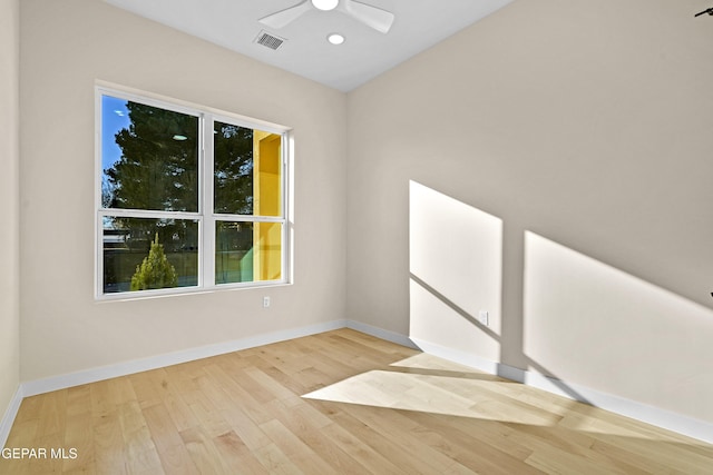 spare room featuring ceiling fan and light hardwood / wood-style flooring