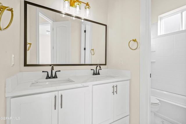 full bathroom with tiled shower / bath combo, vanity, and toilet