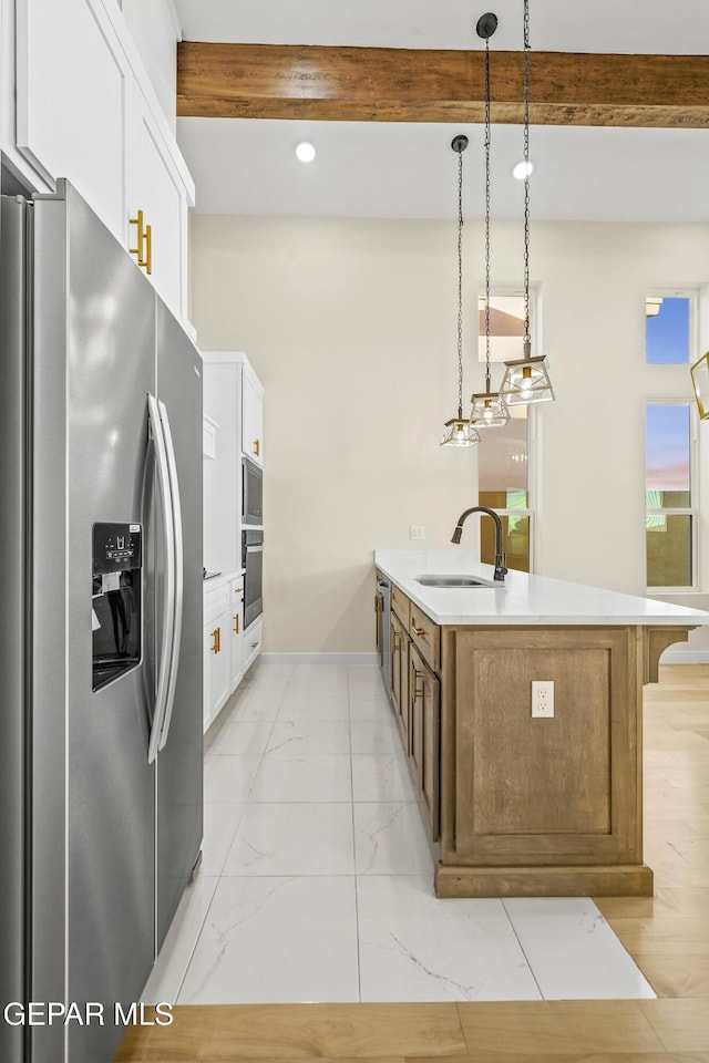 kitchen with white cabinetry, sink, pendant lighting, and appliances with stainless steel finishes