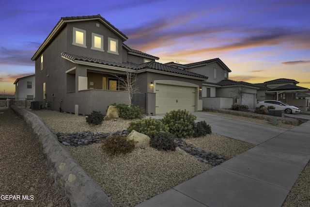 view of front of house featuring central AC and a garage