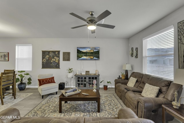 living room with ceiling fan, a healthy amount of sunlight, and light hardwood / wood-style flooring