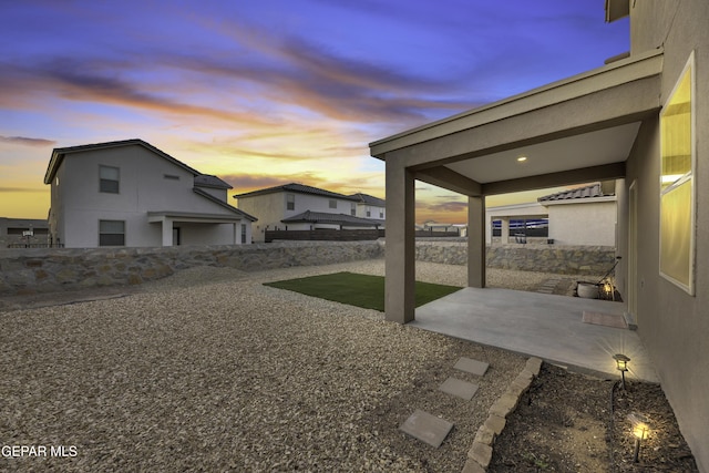 yard at dusk with a patio