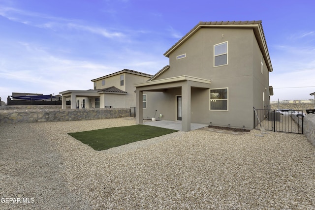 back of house with a patio area