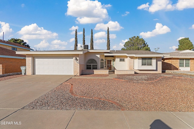 single story home featuring a garage and central air condition unit