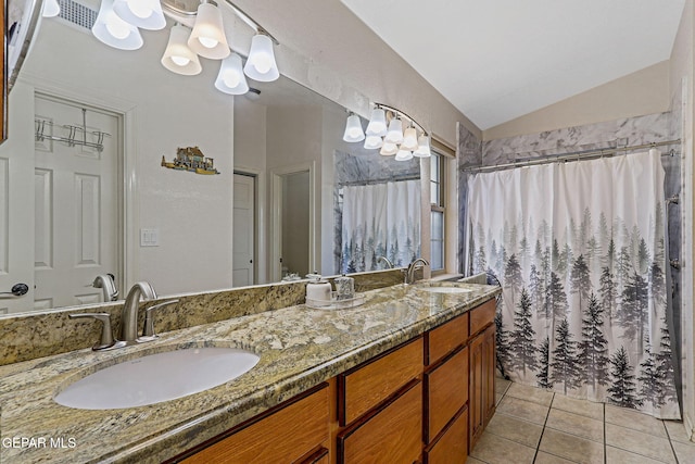 bathroom featuring vanity, a notable chandelier, vaulted ceiling, and tile patterned floors