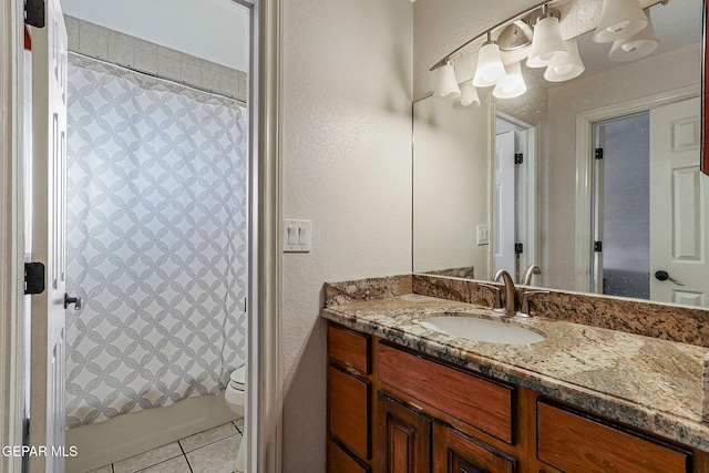 bathroom featuring tile patterned flooring, vanity, and toilet