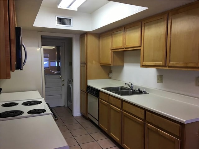 kitchen with light tile patterned flooring, washer / dryer, sink, range with electric stovetop, and dishwasher