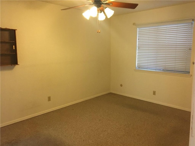 unfurnished room featuring ceiling fan and carpet flooring