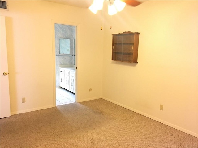 carpeted empty room featuring ceiling fan