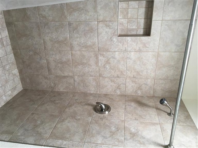 interior details featuring tiled shower