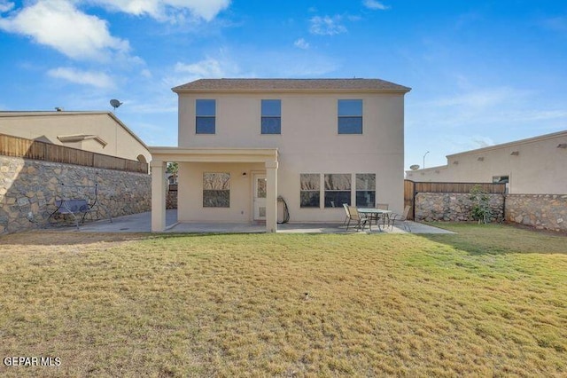 rear view of property with a patio and a yard