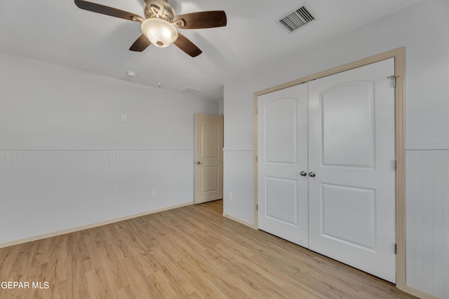 unfurnished bedroom with a closet, ceiling fan, and light hardwood / wood-style flooring