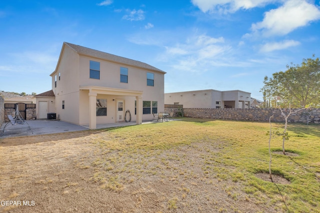 rear view of property with a lawn, central air condition unit, and a patio area