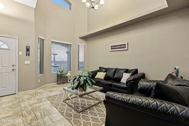 living room with an inviting chandelier and a high ceiling