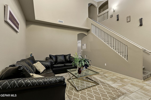 living room featuring a high ceiling