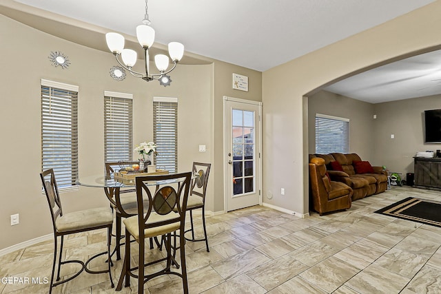 dining space with a notable chandelier