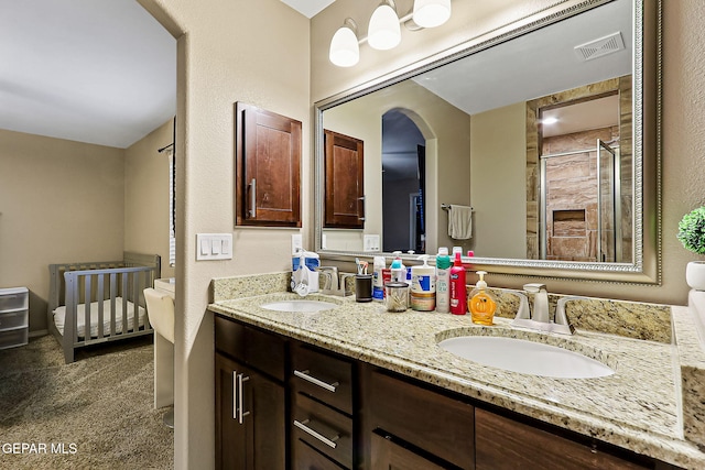 bathroom with vanity and a tile shower